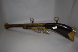A vintage replica wall display blunderbuss gun having brass details and bull head decoration, Cedric
