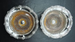 A pair of Victorian silver-plated wine coasters, of fluted circular form with ornamented and