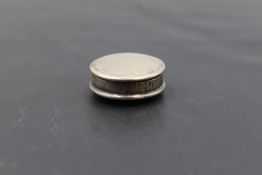 An Edwardian silver pill box, of plain circular form with gilt interior, marks for Birmingham