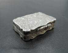 A Victorian silver vinaigrette of shaped rectangular form having pierced gilt grill and extensive