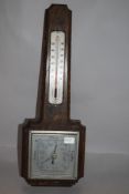 A mid century Smiths oak wall mounted barometer.