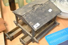 A late Victorian bird seed or similar animal feeder with wire work and wood frame with pull out feed