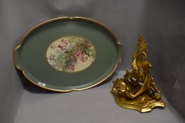 A wooden carved wall scone with gilt finish and a wooden dinner tray