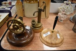 A nautical theme nut cracker with a water well model and glass bottle