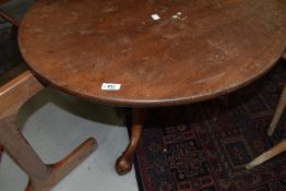 A 19th Century circular tripod table , converted to coffee table, having turned column and elegant