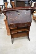 An Arts and Crafts stained frame bureau having open shelves under