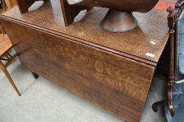 An early 20th century oak drop leaf table.