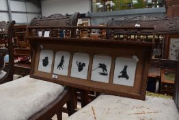 A late Victorian oak galleried photograph frame, now containing five Beatrix Potter related