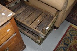 A group of three slatted rustic pine potting trays