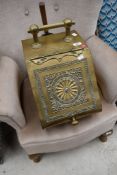 An early 20th century brass coal scuttle with scoop.