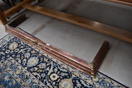 An antique copper fire fender