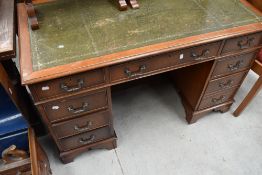 A reproduction twin pedestal mahogany desk.