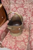 A brass helmet form coal scuttle, with hinged over handle