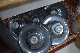 A group of five mid century design circular pendant light fittings, each with small globular central