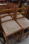 A set of four modern shallow backed stools