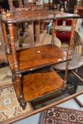 A Victorian three stage whatnot, with spiralled carved columns and shallow fret-cut back