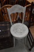 An over painted bent wood chair having art nouveau styling.