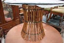 A glass topped cane table.