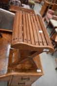 A vintage stool having curved slatted seat.