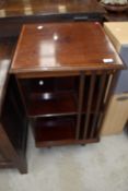 An early 20th century mahogany revolving library having inlaid detailing to edge.