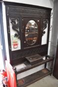 A 19th Century oak hall stand having mythical creature decoration, width approx. 122cm