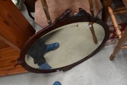 A Victorian mahogany wall mirror having shaped frame