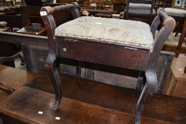 A stained frame piano stool (af)