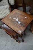 A next of tables having inlaid elephant and foliage to tops, sun bleaching and water marks to