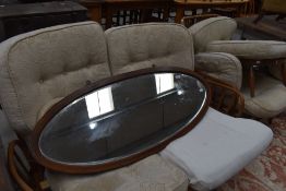 A large Edwardian inlaid mahogany oval wall mirror