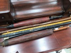 Two vintage measuring sticks, together with two oriental paralsols, walking cane etc.