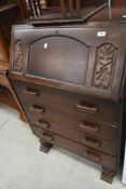 A 1940's oak bureau, of traditional design with trestle type feet to base