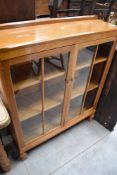 A modern golden oak display cabinet