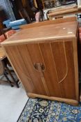 A 20th century light oak utility cupboard