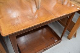 A mid century oak extending dining table, of plain rectangular form with tapering square sectiuon