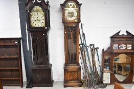 An early 20th Century oak cased long cased clock having brass and silvered dials, with multi chime