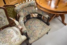 A Victorian or Edwardian salon armchair with later upholstery