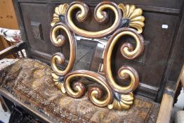 A reproduction French style part gilt scroll frame wall mirror, width approx. 61cm