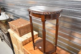 A reproduction occasional table with undertier
