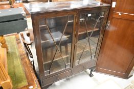 An early 20th Century mahogany display cabinet having astral glazed doors and two lower drawers
