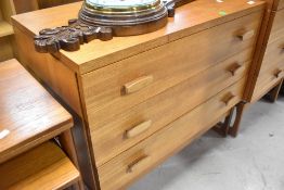 A vintage teak chest of drawers on legs