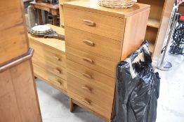A vintage teak chest of drawers on legs