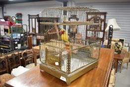 A vintage model budgie in cage, in a kitcsh style