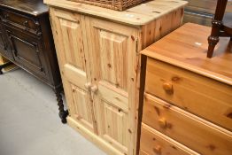 A stripped pine side cabinet