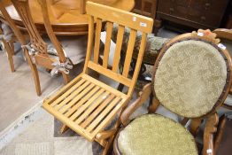 A vintage light stained frame steamer style folding chair