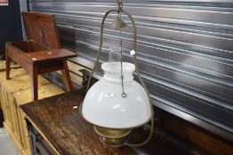 A traditional brass and glass oil type ceiling light fitting