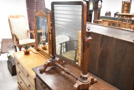 A 19th Century mahogany toilet mirror having elaborate frame and scroll feet