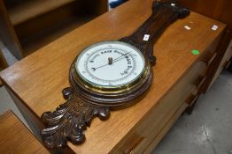 A traditional barometer, oak case, missing thermometer dial