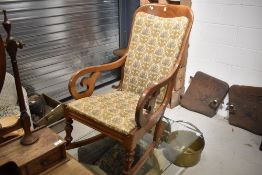 A Victorian mahogany scroll frame rocking armchair