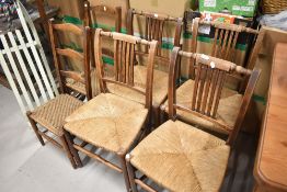 A set of four 19th Century rush seated kitchen chairs and a pair of Edwardian stained frame