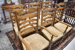A set of traditional ladder back chair (four plus two) having rush seats